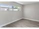 Simple bedroom with gray walls and wood-look floors at 1127 King Arthur Ct # 305, Dunedin, FL 34698