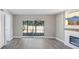 Living room features a fireplace and sliding glass doors at 1127 King Arthur Ct # 305, Dunedin, FL 34698