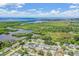 Scenic aerial view of waterfront homes near lush green space with bay and blue skies at 3849 Claremont Dr, New Port Richey, FL 34652