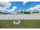 This backyard features a fire pit and white vinyl fence for privacy at 3849 Claremont Dr, New Port Richey, FL 34652