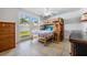 This bedroom features a bunk bed, window to the backyard, and tile flooring at 3849 Claremont Dr, New Port Richey, FL 34652