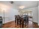 Bright dining room featuring a wooden table, leading to the living area and offering views of the outdoor patio at 3849 Claremont Dr, New Port Richey, FL 34652