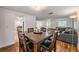 Inviting dining room with a wooden table set for six, flowing into the living room and kitchen, with lots of light at 3849 Claremont Dr, New Port Richey, FL 34652