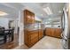 Well-appointed kitchen featuring tile floors, wood cabinets, granite countertops, and stainless steel appliances at 3849 Claremont Dr, New Port Richey, FL 34652
