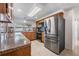 Modern kitchen with stainless steel appliances, wooden cabinets, tile floors, and ample counter space for cooking at 3849 Claremont Dr, New Port Richey, FL 34652