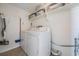 This laundry room offers shelving for storage and a newer washer and dryer at 3849 Claremont Dr, New Port Richey, FL 34652