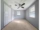 Second bedroom with ceiling fan, large closet, and gray colored walls at 3809 Burden St, New Port Richey, FL 34652