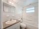 Clean bathroom with white tile, a bathtub, and a single sink vanity at 3809 Burden St, New Port Richey, FL 34652