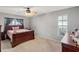 Spacious bedroom with wood bed frame and window at 3077 Ardenwood Dr, Spring Hill, FL 34609