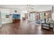 Open-concept living area with laminate flooring and access to pool at 3077 Ardenwood Dr, Spring Hill, FL 34609