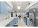 Galley style kitchen with stainless steel appliances at 3077 Ardenwood Dr, Spring Hill, FL 34609