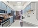 Kitchen boasts light blue cabinets and stainless steel appliances at 3077 Ardenwood Dr, Spring Hill, FL 34609