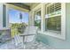 Relaxing white porch swing on a paver patio overlooking a tree-lined street at 6039 Dusk Rose Ln, Brooksville, FL 34601