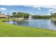 Serene lake with fountain and lush landscaping at 4644 Coachmen Rd, New Port Richey, FL 34655