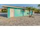 Turquoise beach club restrooms facility with painted white door and manicured palm trees at 4931 Docner St # 4931, New Port Richey, FL 34652
