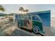 A green, vintage VW van artfully painted as a vibrant mural, enhancing the beach scene at 4931 Docner St # 4931, New Port Richey, FL 34652