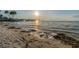 Beautiful beach view with calm water and a picturesque pier in the distance at sunset at 4931 Docner St # 4931, New Port Richey, FL 34652