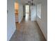 Bright hallway with tiled floors, neutral paint, and natural light from the window at 4931 Docner St # 4931, New Port Richey, FL 34652