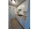 Well-lit kitchen features white cabinets, stainless steel sink, and granite-style countertops at 4931 Docner St # 4931, New Port Richey, FL 34652