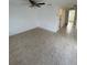 Open living room with tiled floors leading to the kitchen, creating a seamless flow at 4931 Docner St # 4931, New Port Richey, FL 34652