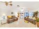 Bright living room with comfy sofas, a large TV, and tiled floors at 7319 Greystone Dr, Hudson, FL 34667