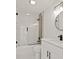 Modern bathroom with white vanity, glass shower, and black accents at 18101 Mason Smith Rd, Brooksville, FL 34604