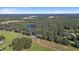 Aerial view of the property, highlighting its size and pond at 18101 Mason Smith Rd, Brooksville, FL 34604