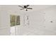Bedroom with a view of the backyard, tile flooring, and ceiling fan at 18101 Mason Smith Rd, Brooksville, FL 34604