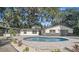 Kidney shaped pool with surrounding patio at 18101 Mason Smith Rd, Brooksville, FL 34604