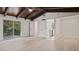 Bright bedroom with wood-look floors and access to a hallway at 18101 Mason Smith Rd, Brooksville, FL 34604
