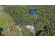 Aerial view of property with pool and nearby lake at 18101 Mason Smith Rd, Brooksville, FL 34604