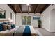 Main bedroom with wood ceiling, sliding glass doors to deck, and plush bedding at 18101 Mason Smith Rd, Brooksville, FL 34604