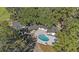 Aerial view showing home, pool, and surrounding trees at 18101 Mason Smith Rd, Brooksville, FL 34604