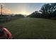 Property with large grassy area and trees at sunset at 18101 Mason Smith Rd, Brooksville, FL 34604