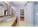 Elegant bathroom with double vanities, a view into the bedroom, and glass sinks at 13931 Chandron Dr, Odessa, FL 33556