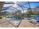 Enclosed pool and patio area with water feature at 13931 Chandron Dr, Odessa, FL 33556