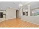 Bright dining room features hardwood floors and a view into the kitchen at 13931 Chandron Dr, Odessa, FL 33556