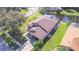 House with brown roof and pool near a pond at 13931 Chandron Dr, Odessa, FL 33556