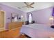 Bright bedroom with a king-size bed, dresser, and ceiling fan at 13931 Chandron Dr, Odessa, FL 33556