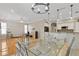Bright dining area with glass-top table and chandelier at 13931 Chandron Dr, Odessa, FL 33556