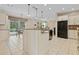 Modern kitchen with island, breakfast nook, and pool view at 13931 Chandron Dr, Odessa, FL 33556