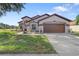 Single-story house with brown garage door and landscaping at 13931 Chandron Dr, Odessa, FL 33556