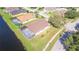 House with brown roof and pool, next to pond at 13931 Chandron Dr, Odessa, FL 33556