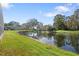 Scenic pond view with lush green grass and trees at 13931 Chandron Dr, Odessa, FL 33556
