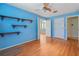 Light blue bedroom with wood floors and built-in shelving at 13931 Chandron Dr, Odessa, FL 33556