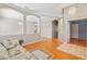Light and airy living room with hardwood floors and access to hallway at 13931 Chandron Dr, Odessa, FL 33556