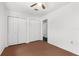 Spacious bedroom with ceiling fan, double closets, and neutral decor at 10221 Elgin Blvd, Spring Hill, FL 34608