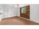 Versatile room with built-in shelving and wood-paneled wall at 10221 Elgin Blvd, Spring Hill, FL 34608