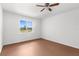 Bedroom with ceiling fan and window overlooking a yard at 10221 Elgin Blvd, Spring Hill, FL 34608