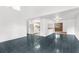 Bright living area with dark tile floors and open kitchen view at 10221 Elgin Blvd, Spring Hill, FL 34608
